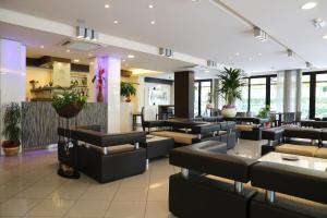 a restaurant with couches and tables in a lobby at Hotel Ambra in Cesenatico