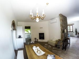 a dining room and living room with a chandelier at Villa Il Cipresso in Terranuova Bracciolini