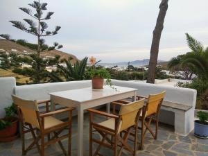 a white table and chairs on a patio at Studio Elisabeth in Agios Ioannis