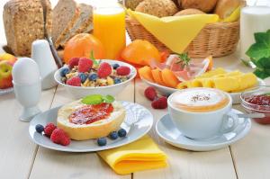 un tavolo con prodotti per la colazione e una tazza di caffè di Bed & Breakfast La Rocca a Taormina