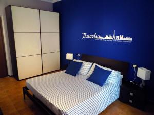 une chambre avec un lit avec un mur bleu dans l'établissement Il Ristoro di Garibaldi, à La Spezia