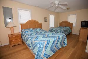 a bedroom with two beds and a ceiling fan at Avon Cottages in Avon