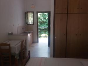 kuchnia ze stołem i drzwi do podwórza w obiekcie Paparizou Apartments w mieście Kokino Nero