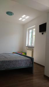 a bedroom with a bed and a television in a room at La vie est belle in Finale Ligure +42 photos