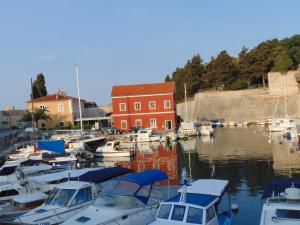 a group of boats docked in a harbor with a red building at Studio Apartment B&B Zadar Sunset in Zadar