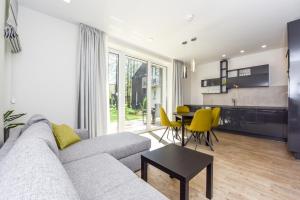 a living room with a couch and a table at Sakalo 44 in Palanga