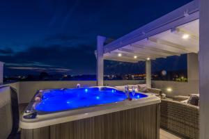 a blue hot tub on a balcony at night at Apartments Sun Resort Nikolina in Bibinje