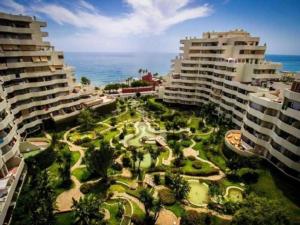 an aerial view of a park with palm trees and buildings at Park Beach Benalmadena in Benalmádena