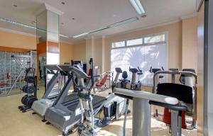 a gym with several tread machines and a window at Park Beach Benalmadena in Benalmádena