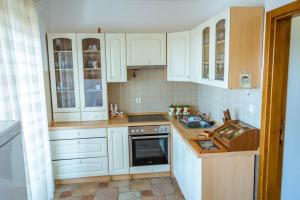 a kitchen with white cabinets and a sink at Villa Lidija in Budva