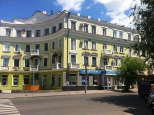 a large yellow building on the side of a street at VIP apartment Karl Marks Avenue in Kryvyi Rih
