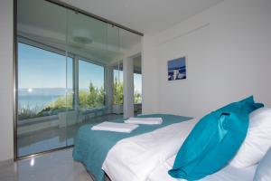 a bedroom with a bed with a view of the ocean at Apartment Villa Balevski in Ohrid