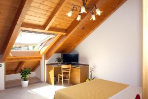 a room with a bed and a desk with a television at Affittacamere "Gilda INN Agerola" in Agerola