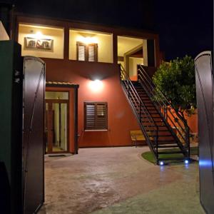 a house with a staircase in front of it at night at Artista B&B in Càbras
