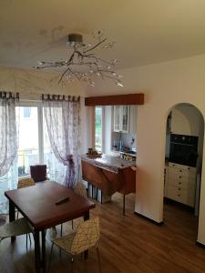 a kitchen and living room with a table and a dining room at Costaguta Apartment in Rapallo