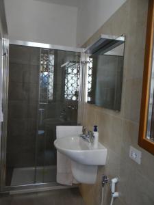a bathroom with a sink and a shower at Palazzo Boldù - Ca'Arlecchino in Venice