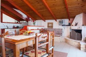 a kitchen with a table and a kitchen with a fireplace at Sea Side Apartments & Studios-Renovated in Tsilivi