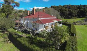 an aerial view of a house with a red roof at Oakura Bay Villa - Stay Waiheke in Te Whau Bay
