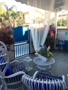 a patio with chairs and a table and a pool at The blue house in Marsala