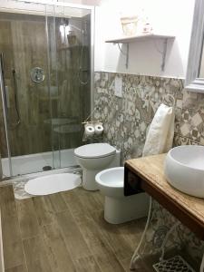 a bathroom with a toilet and a shower at The blue house in Marsala
