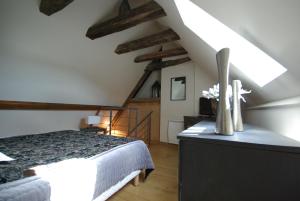 A bed or beds in a room at LogisHotels Le Relais du Quercy