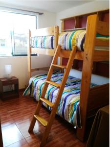 a bedroom with two bunk beds and a bed at White Hope Apartment in Lima