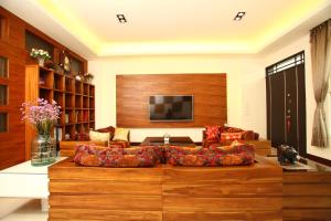 a living room with a couch and a tv at When the Swallow Flying B&B in Taitung City