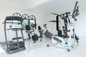 a gym with several exercise equipment in a room at VC Hotel Phayao in Phayao