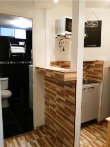 a kitchen with a counter with a microwave at White Hope Apartment in Lima