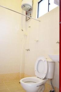 a bathroom with a toilet and a sink at Skyville Zen Resort,Kundasang in Kundasang