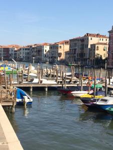 a group of boats docked at a dock with buildings at Venetian House in Venice
