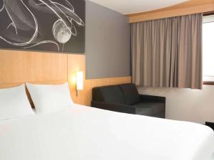 Rúm í herbergi á ibis 3 Lacs Neuchâtel
