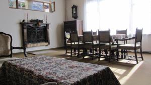 a room with a table and chairs and a fireplace at Dili Villa in Dilijan