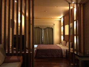 Postel nebo postele na pokoji v ubytování ChangSing Business Motel