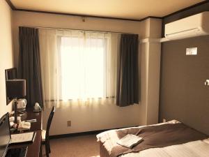Ένα ή περισσότερα κρεβάτια σε δωμάτιο στο Hotel Tomakomai Green Hills