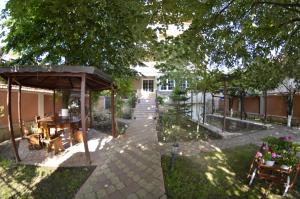 a garden with a pavilion and a table and chairs at Vila Cristal Costinesti in Costinesti