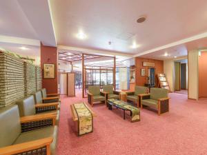 a waiting area in a hospital with chairs and tables at Hotel Hagoromo in Shizuoka
