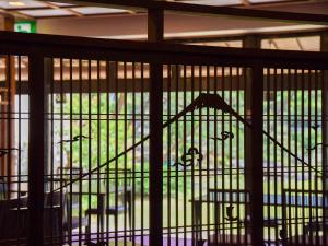 a bird cage with a chair in it at Hotel Hagoromo in Shizuoka