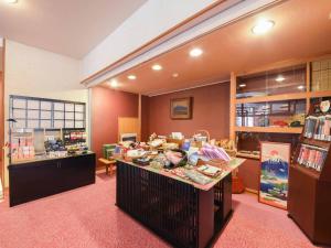 a room with a table with food on it at Hotel Hagoromo in Shizuoka