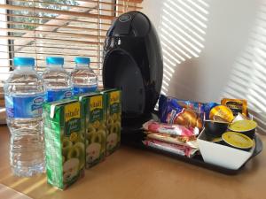 a table with some bottled water and some food at Osterley Studio Room in Isleworth