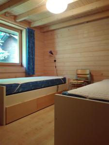 a bedroom with two beds and a window at Pusterummet, Klåveröd in Klåveröd