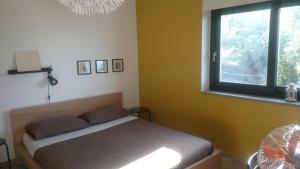 a bedroom with a bed and a window at La Casa del Riccio in Tindari