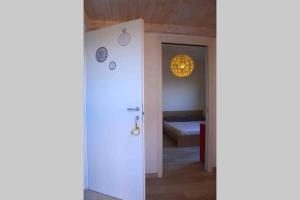 a room with a door and a bedroom with a bed at La Casa del Riccio in Tindari