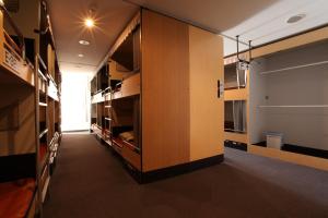 a room with a hallway with wooden cabinets at Kashimayari Sports Village in Omachi