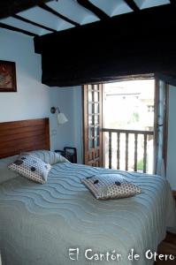 a bedroom with a bed with two pillows on it at Estudios El Canton de Otero in Santillana del Mar
