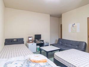 Un pat sau paturi într-o cameră la Kenrokuen