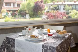 una mesa con un plato de comida en ella con una ventana en B&B Dolce Risveglio, en Puegnago sul Garda