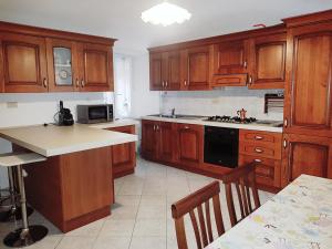 a kitchen with wooden cabinets and a stove top oven at Appuntamento Al porto in Savona