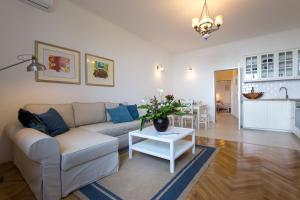 a living room with a couch and a table at Villa Belsito in Lovran