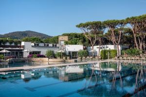 a large pool of water with trees and buildings at Riva Del Sole Resort & SPA in Castiglione della Pescaia